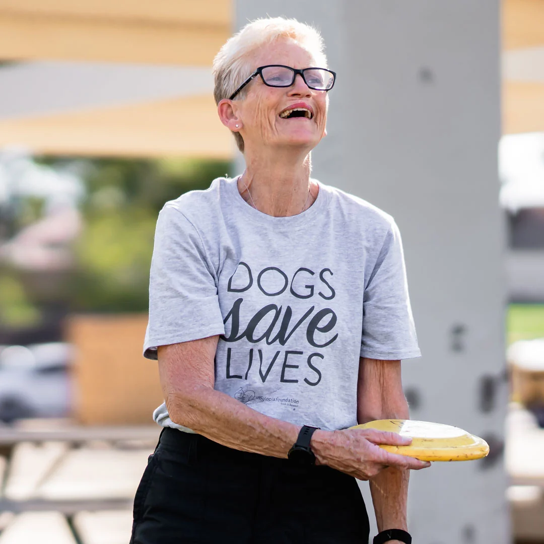  Woman wearing Dogs Save Lives Shirt with dog